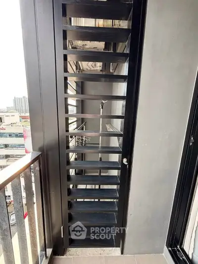 Modern balcony with sleek metal railing and city view, perfect for urban living.