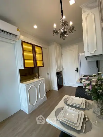 Elegant kitchen with chandelier and modern appliances in a stylish apartment