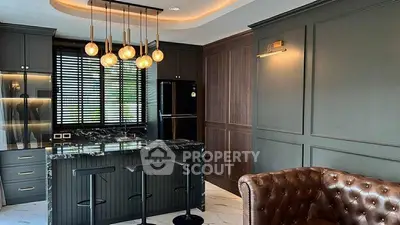 Luxurious modern kitchen with marble island and stylish lighting in elegant apartment.