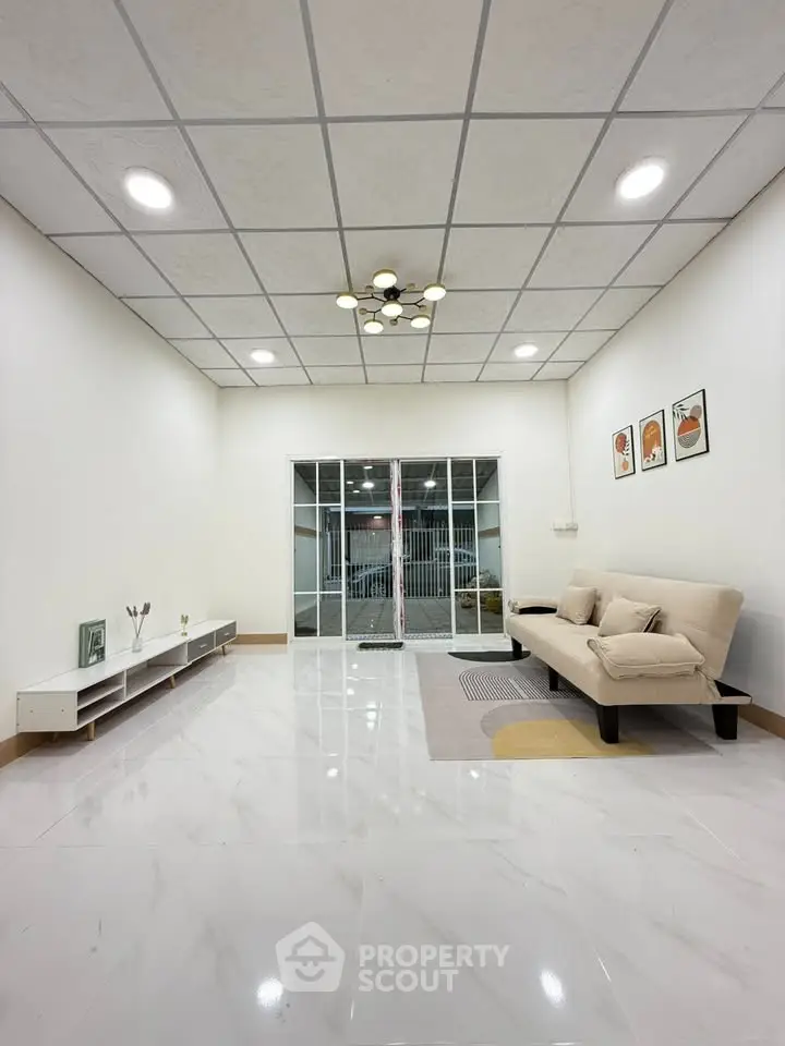 Spacious modern living room with sleek design and cozy seating area.