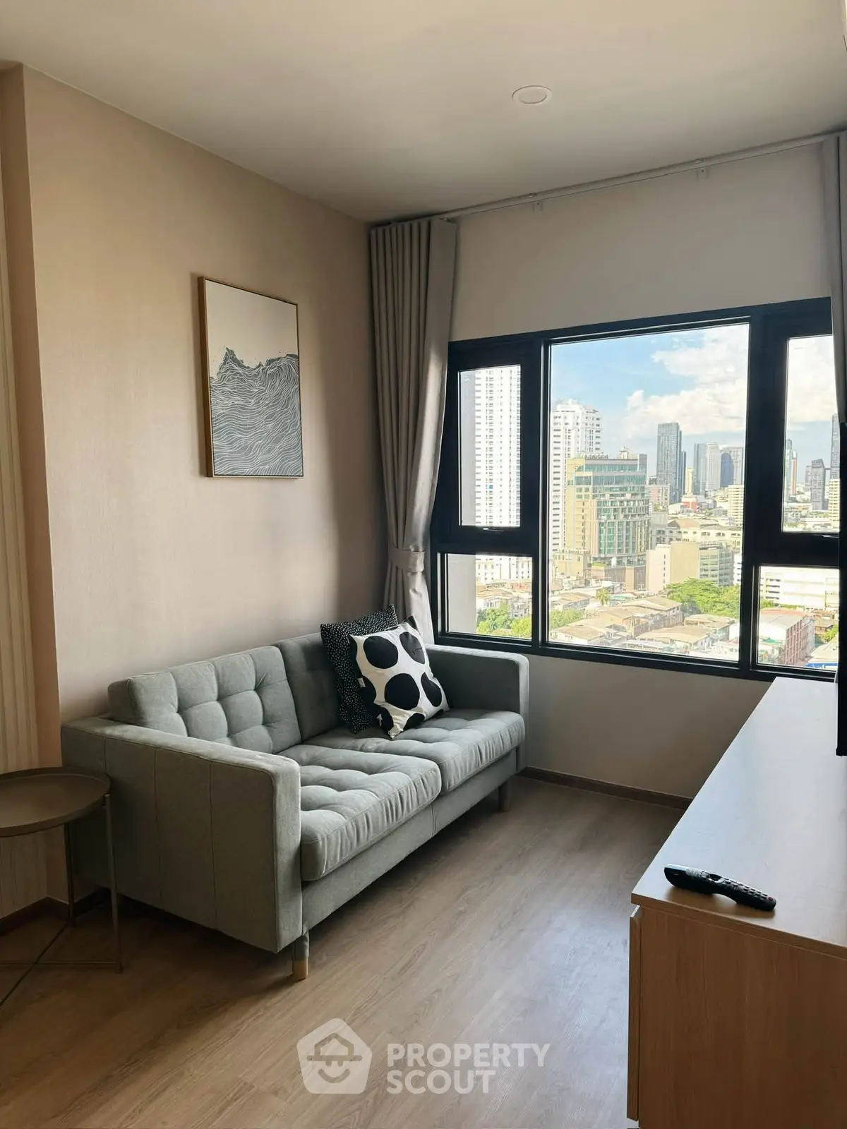 Modern living room with city view, featuring a stylish sofa and large window.