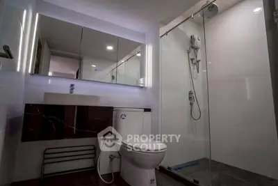 Modern bathroom with sleek fixtures and glass shower enclosure