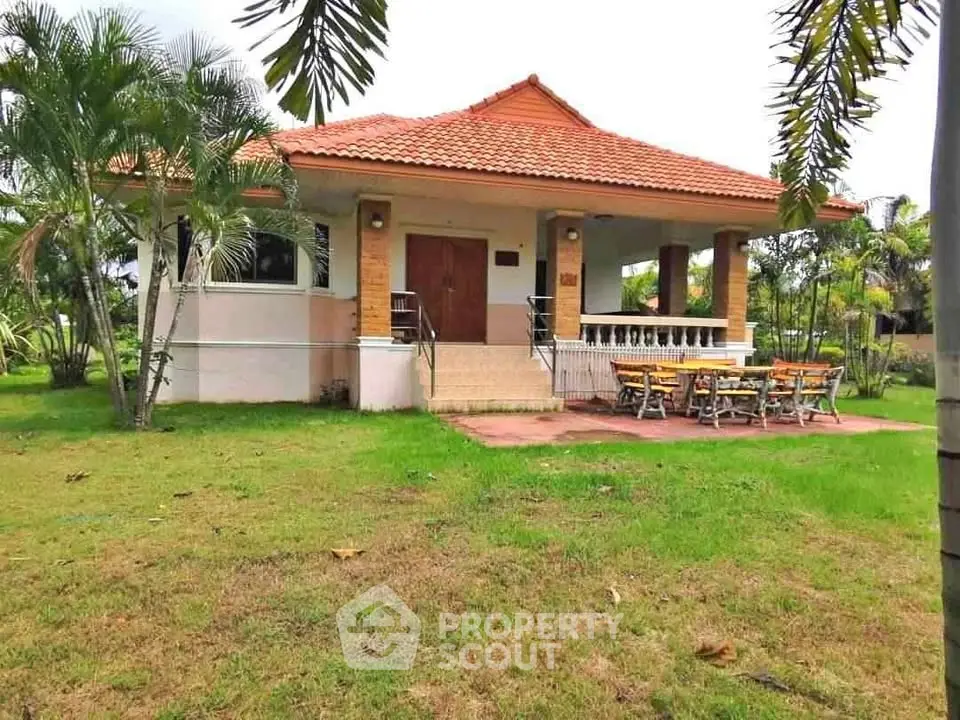 Charming single-story house with spacious garden and inviting porch.