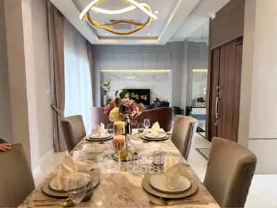 Luxurious dining area with elegant table setting and modern lighting in a stylish apartment.
