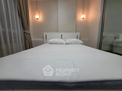 Cozy bedroom with modern lighting and elegant decor, perfect for relaxation and comfort.