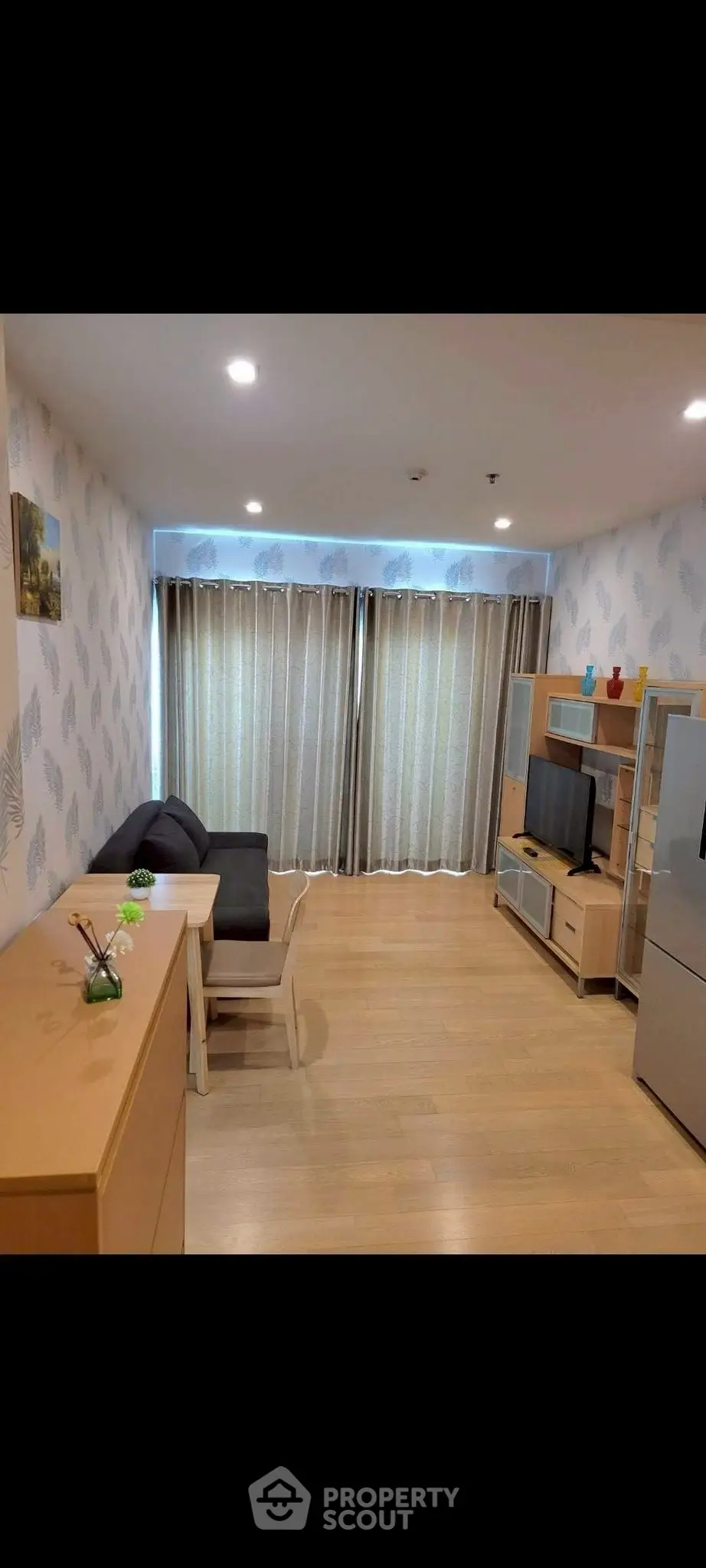 Modern living room with stylish furniture and entertainment center, featuring elegant lighting and wooden flooring.