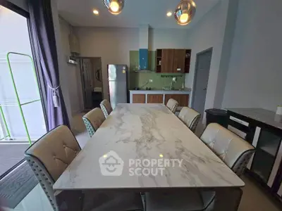 Modern dining area with marble table and stylish chairs in open kitchen layout