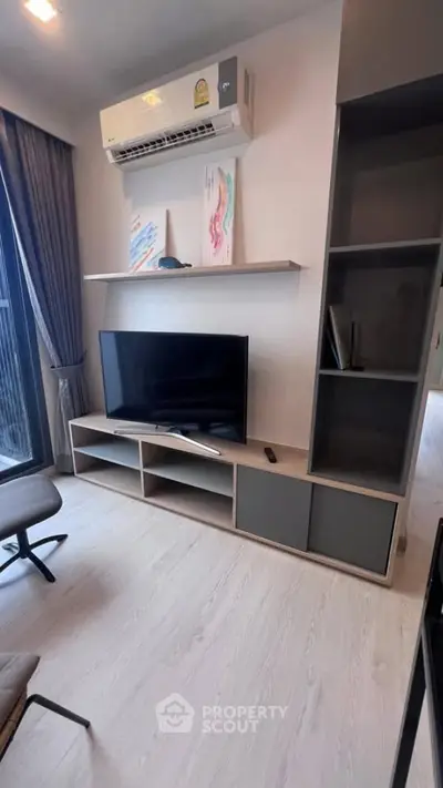 Modern living room with sleek TV setup and air conditioning