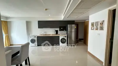 Modern kitchen with sleek appliances and open layout in stylish apartment.