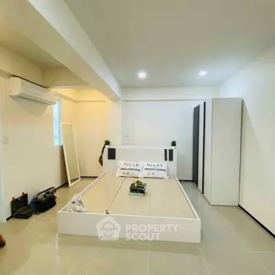 Modern bedroom with sleek design and air conditioning in a minimalist setting.