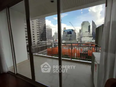 Spacious balcony with city skyline view, perfect for urban living.