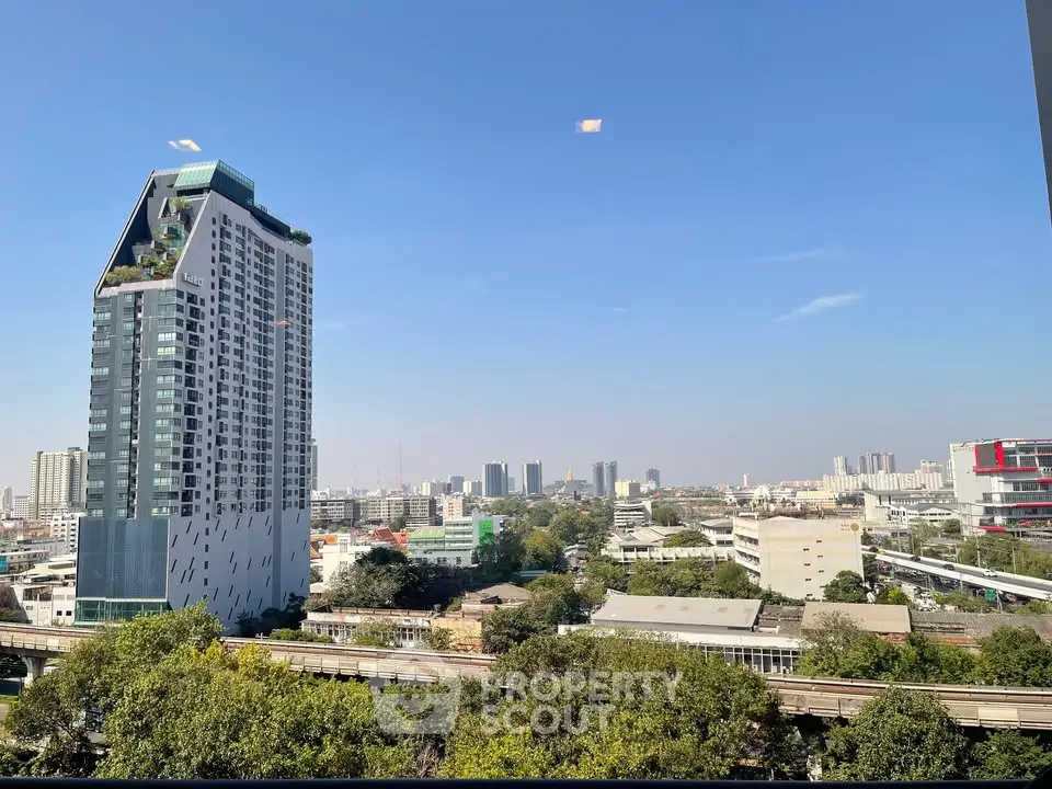 Stunning cityscape view with modern high-rise building and clear blue sky.