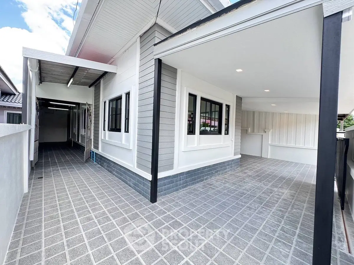 Modern exterior of a stylish home with covered parking and sleek design.