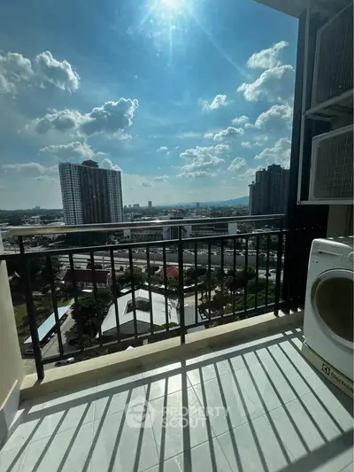 Stunning balcony view with cityscape and clear blue sky, perfect for urban living.