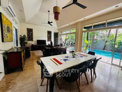Spacious living room with pool view, modern decor, and open layout for luxury living.