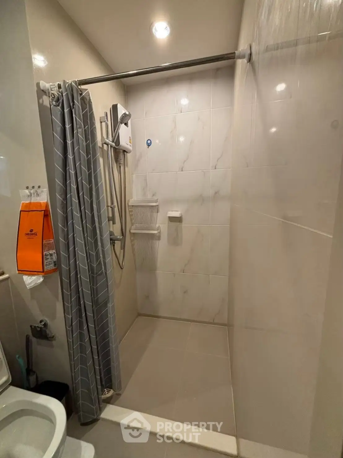 Modern bathroom with shower and curtain in a sleek design.