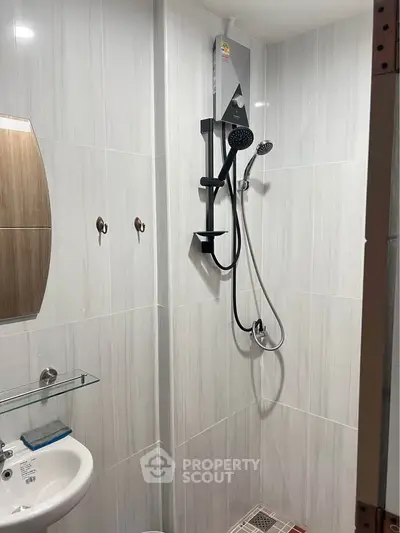 Modern bathroom with sleek shower and elegant tile design, perfect for a contemporary home.