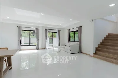 Spacious modern living room with large windows and natural light
