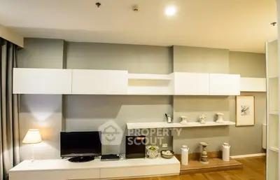 Modern living room with sleek white cabinetry and stylish decor