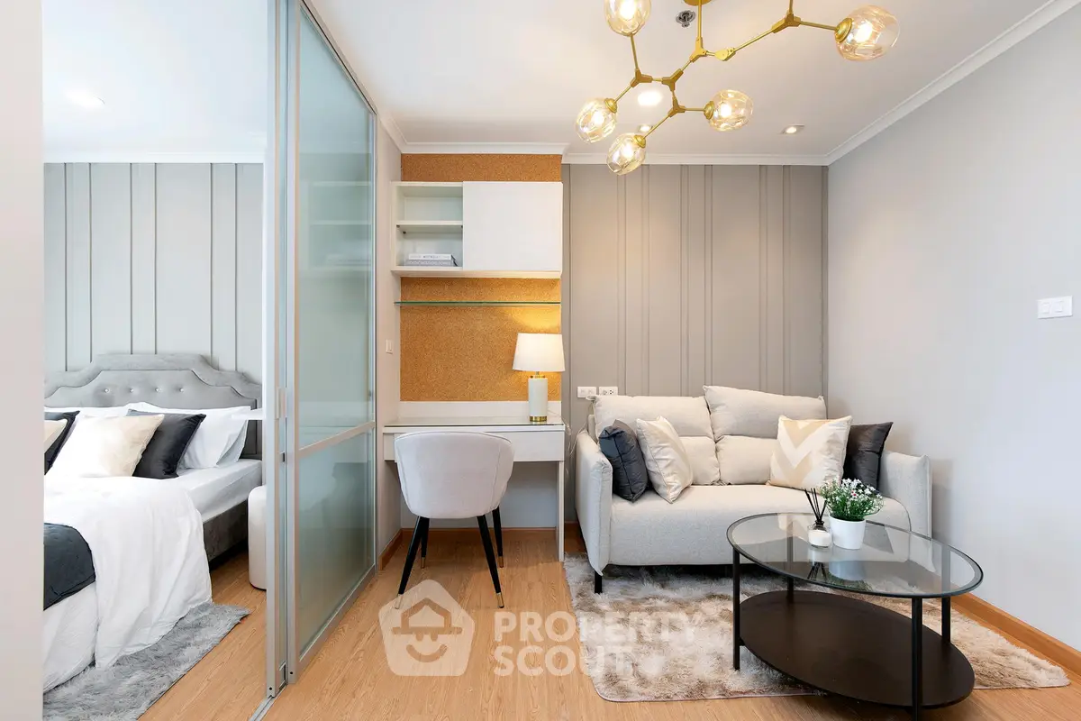 Modern living room with cozy sofa and stylish lighting next to a chic bedroom