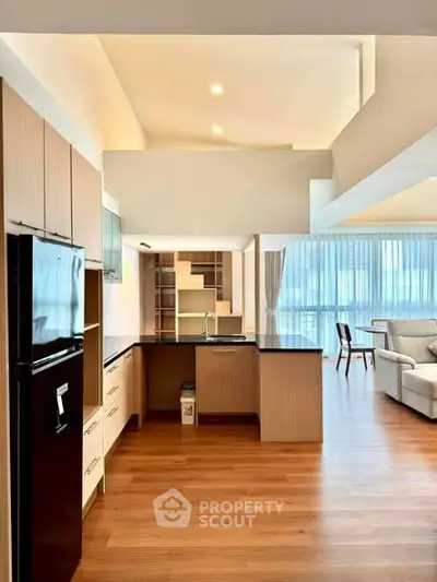 Spacious open-plan kitchen and living area with modern design and ample natural light.