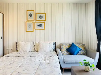 Cozy bedroom with stylish decor and comfortable seating area