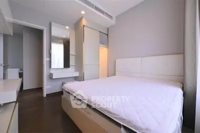 Modern bedroom with sleek design and ample natural light, featuring a comfortable bed and stylish decor.