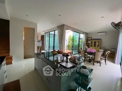 Spacious modern kitchen and dining area with open layout and garden view.