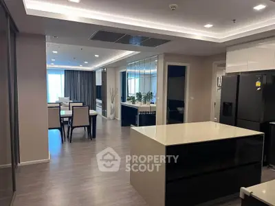 Spacious modern open-plan kitchen and dining area with sleek design and ample natural light.