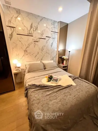 Luxurious bedroom with elegant marble accent wall and cozy lighting