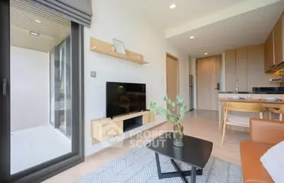 Modern living room with sleek furniture and open kitchen layout