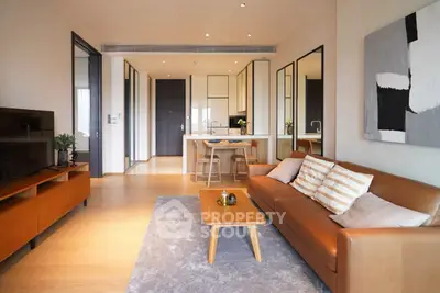 Modern living room with stylish furniture and open kitchen layout