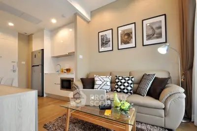 Modern living room with stylish decor and open kitchen layout in a cozy apartment.