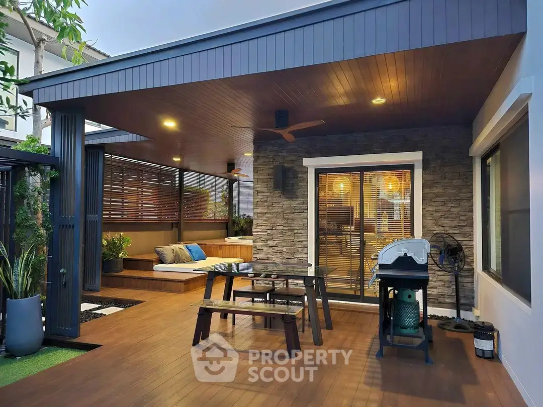 Stylish outdoor patio with modern seating and barbecue area, perfect for entertaining guests.