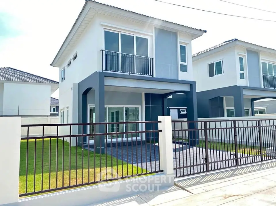 Modern two-story house with sleek design and spacious front yard