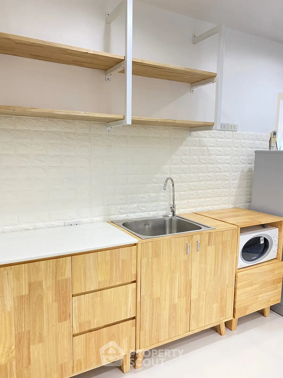 Modern kitchen with wooden cabinets and built-in washing machine
