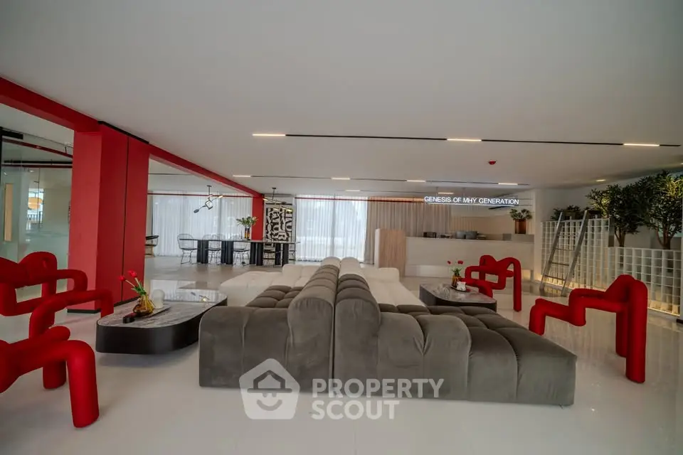 Luxurious modern living room with stylish red and gray furniture, perfect for entertaining.