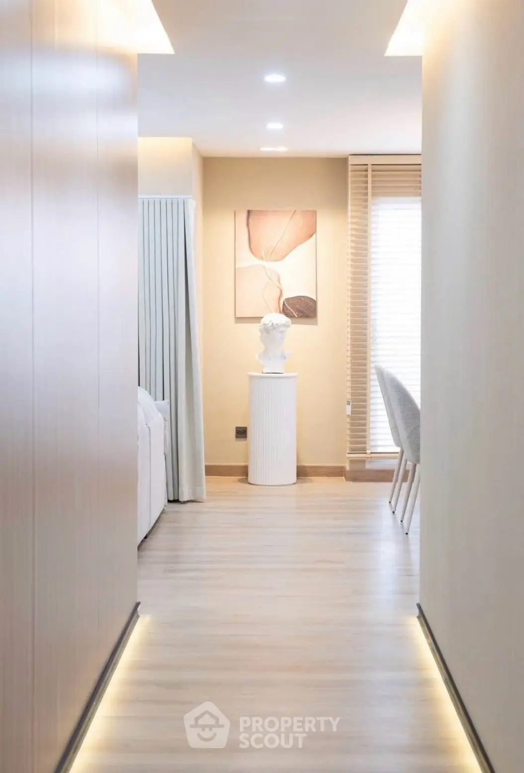 Modern hallway with elegant decor and soft lighting in a stylish apartment.