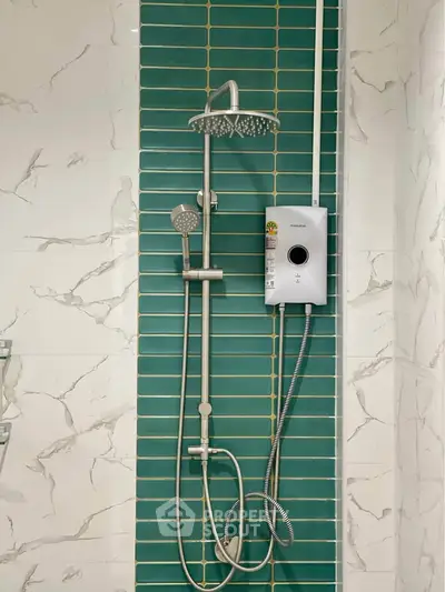Modern bathroom with stylish shower and elegant green tile accent wall.