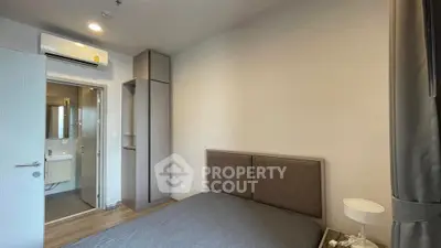 Modern bedroom with ensuite bathroom and sleek design in a contemporary apartment.