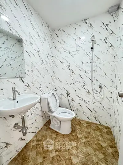 Modern bathroom with marble walls and sleek fixtures