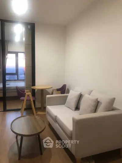 Cozy living room with modern furniture and natural light, perfect for relaxation and entertaining.