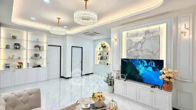 Luxurious living room with elegant chandeliers and marble accents