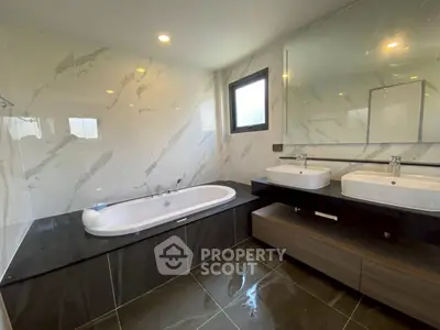 Luxurious modern bathroom with dual sinks and elegant marble finishes
