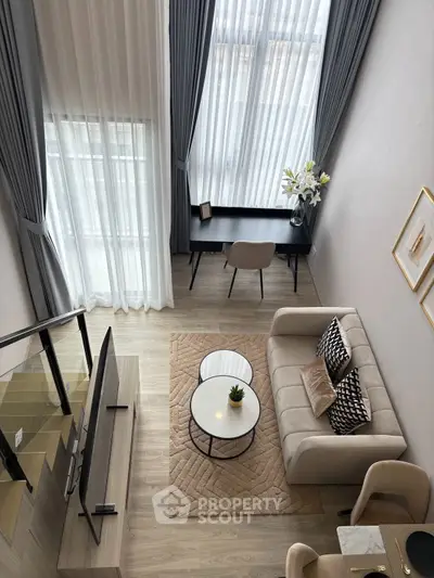 Modern loft-style living room with high ceilings and elegant decor