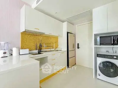Modern kitchen with sleek appliances and vibrant yellow backsplash