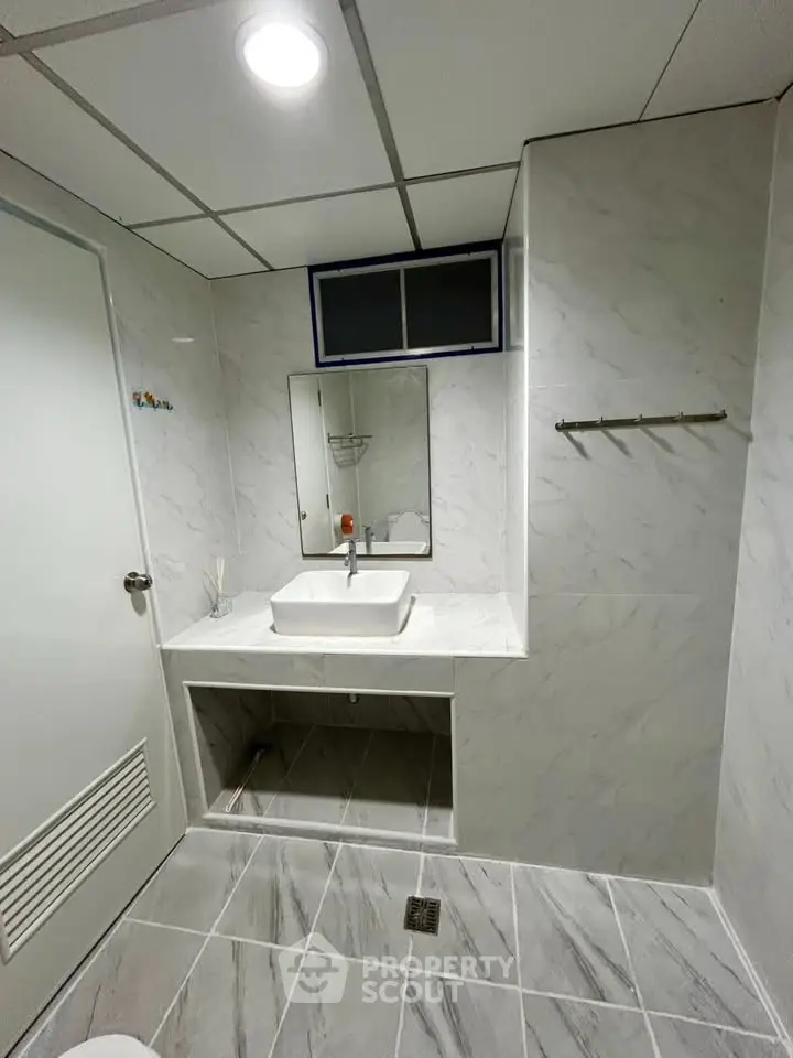 Modern bathroom with marble tiles and sleek sink design