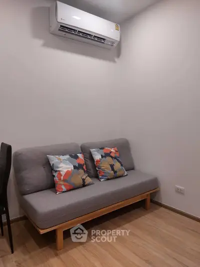 Cozy living room with modern sofa and air conditioning unit