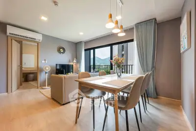 Modern living room with dining area and mountain view from balcony