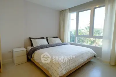 Bright and cozy bedroom with large window and modern decor